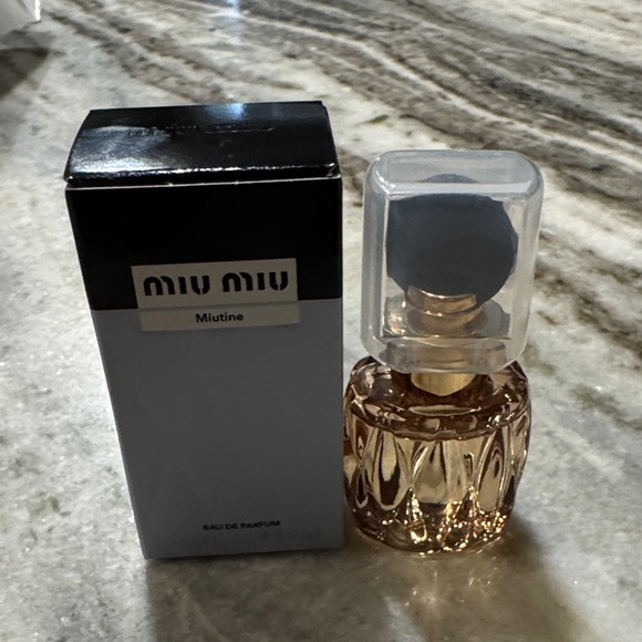 Miu Miu Eau de Parfum with Black top and clear Cap and Gold Accents dab on - Picture 2 of 3